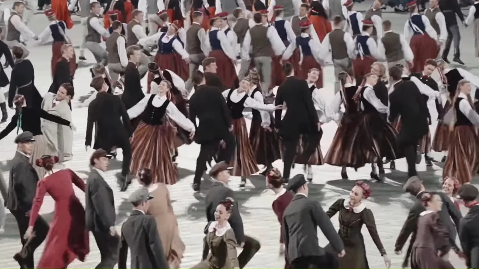 Folk dancers in traditional dress performing at a Latvian Song and Dance Celebration