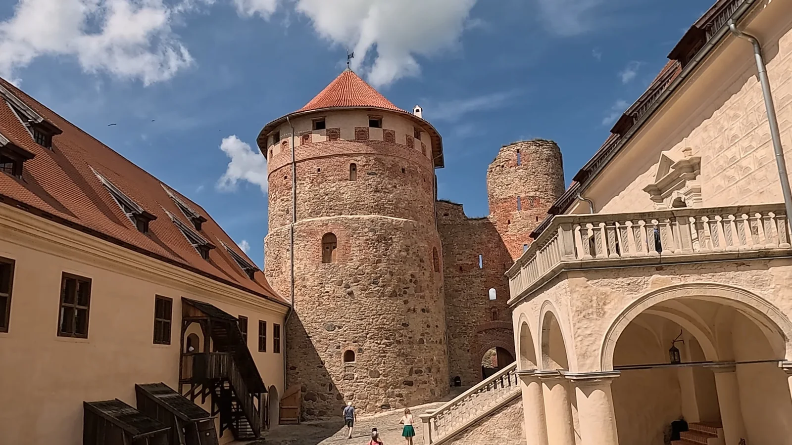 Bauska Castle courtyard with restored Renaissance buildings and medieval towers